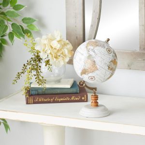 Discover the beauty of the Deco 79 Marble Globe with Marble Base in Teal. This contemporary globe features a white marble base, bronze iron and wood frame, and a plastic globe covered in paper material. With its teal and white polished finish, it showcases multicolored continents and islands surrounded by teal bodies of water. Perfect as accent or centerpiece decor, this small-sized globe measures 6"W x 11"H and weighs 2 lbs. 